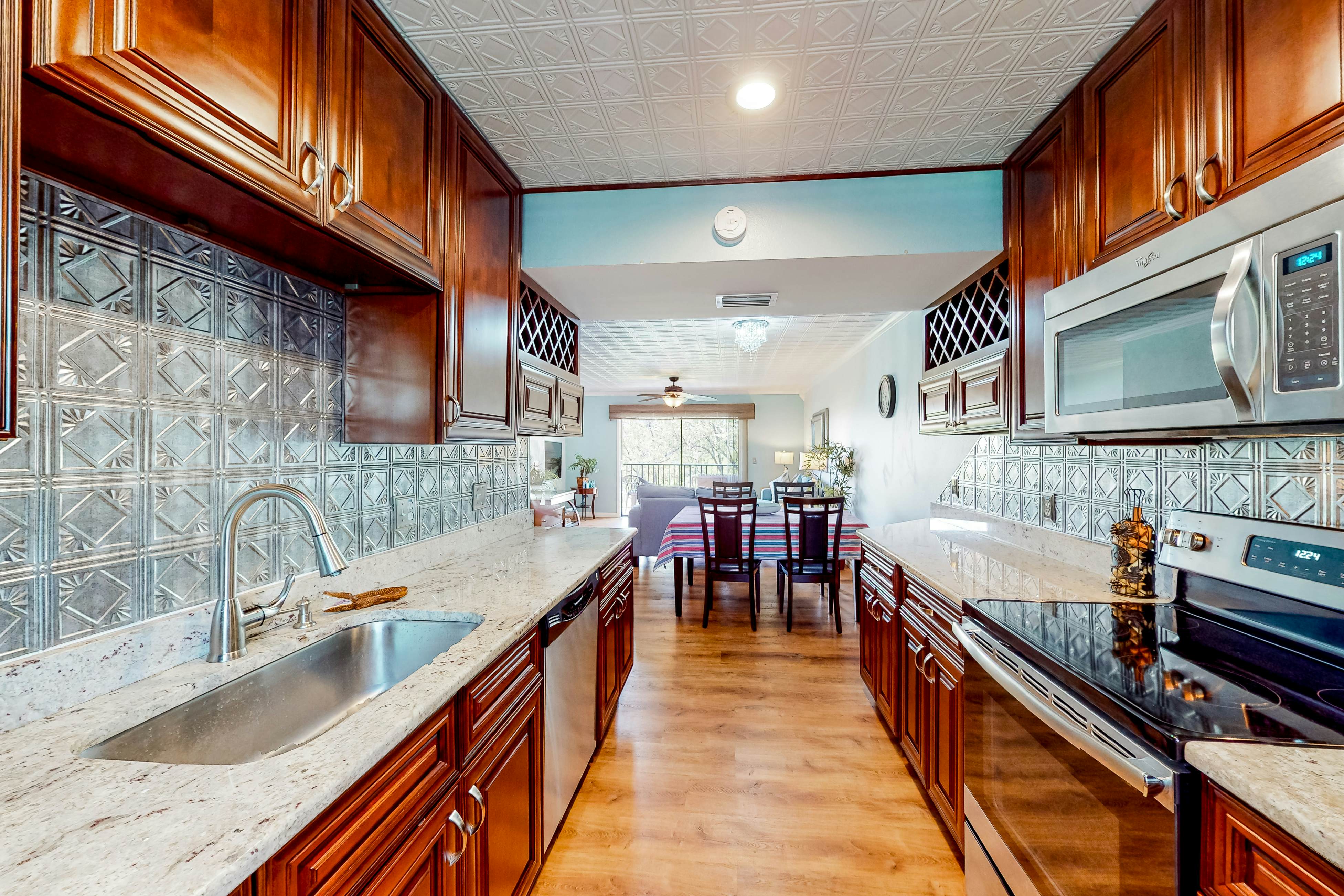 Beachfront condo with balconies, grill, AC, & pool access - steps from the sand