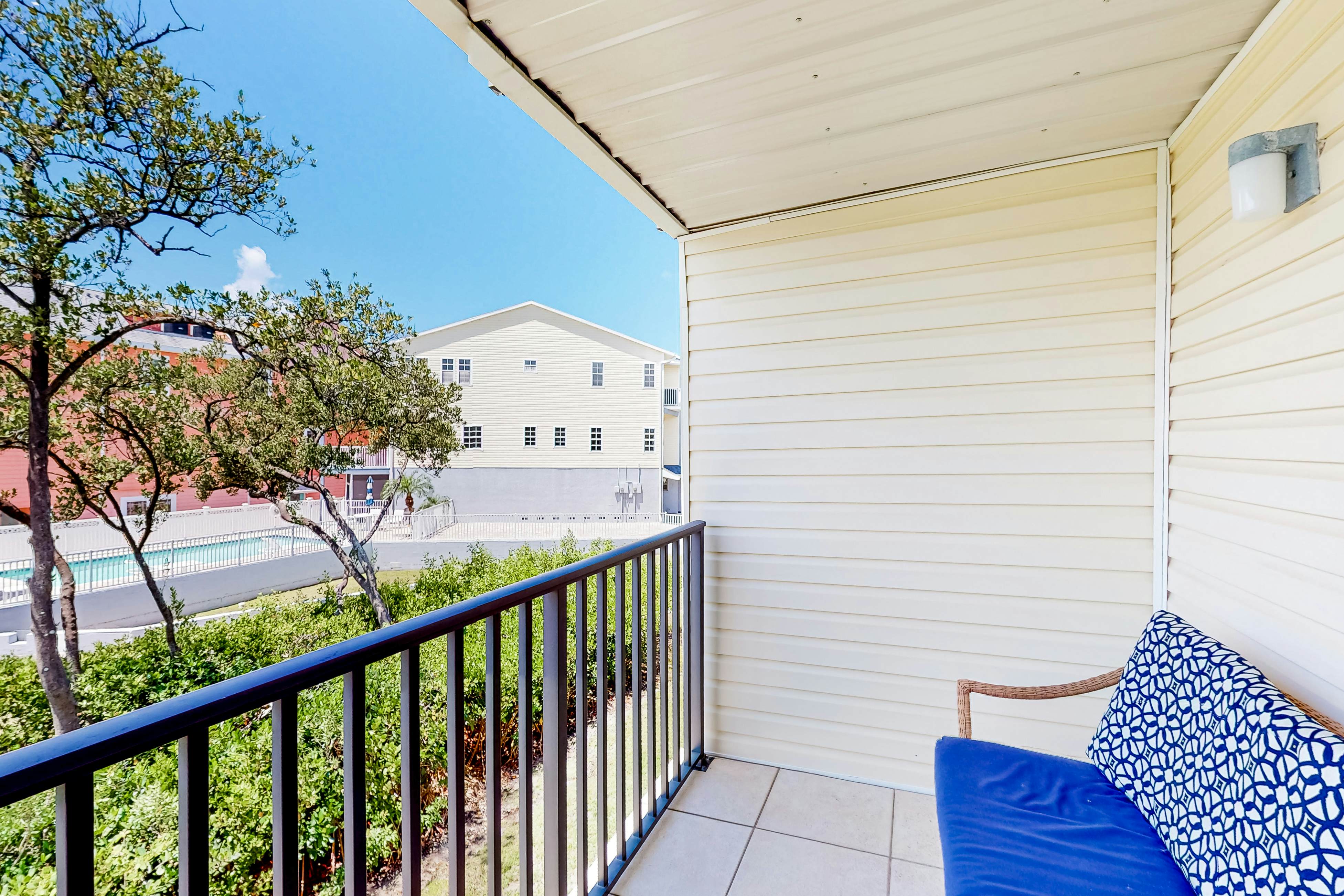 Beachfront condo with balconies, grill, AC, & pool access - steps from the sand