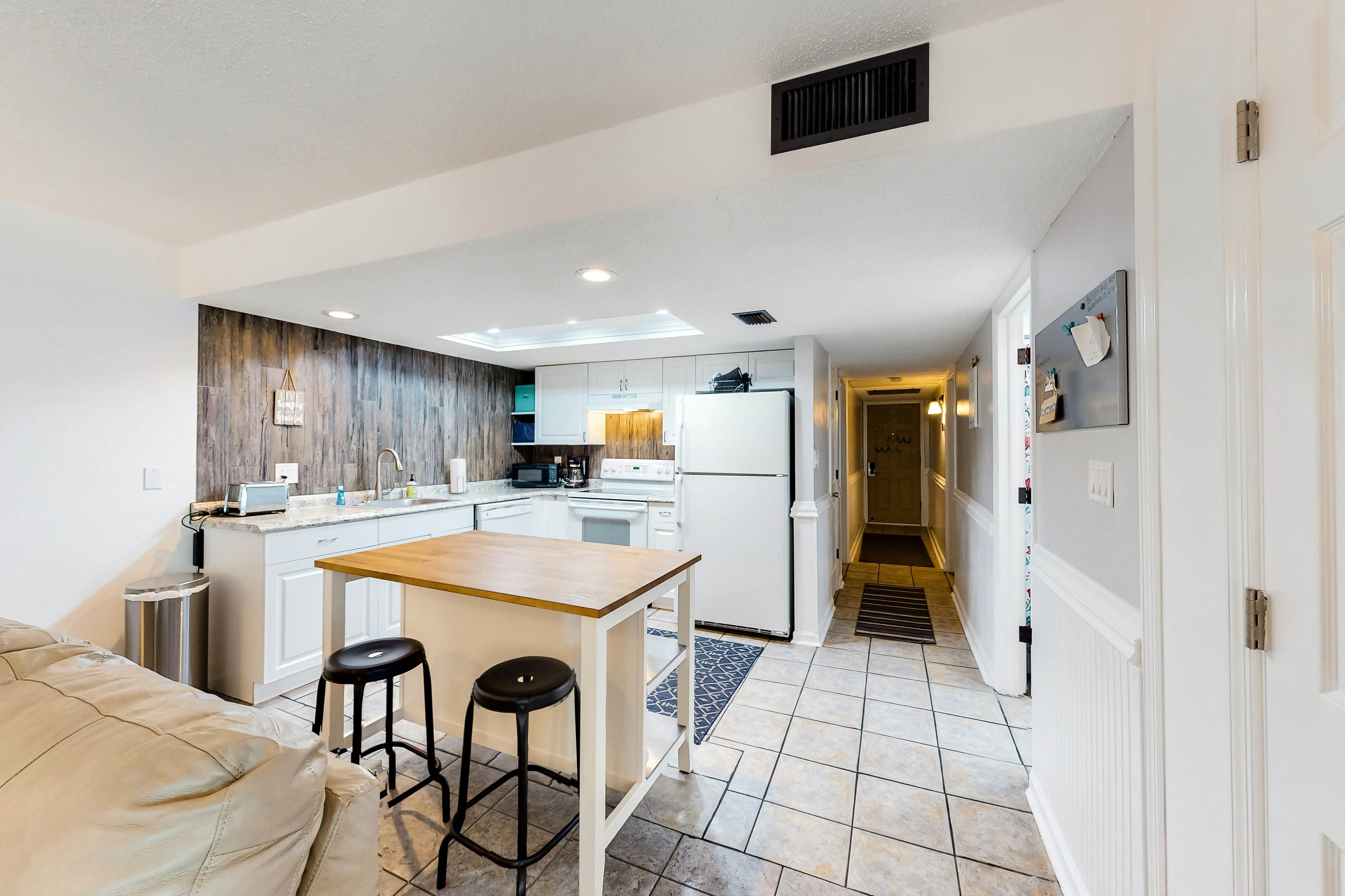 Updated beachside corner condo with pool and private wraparound balcony