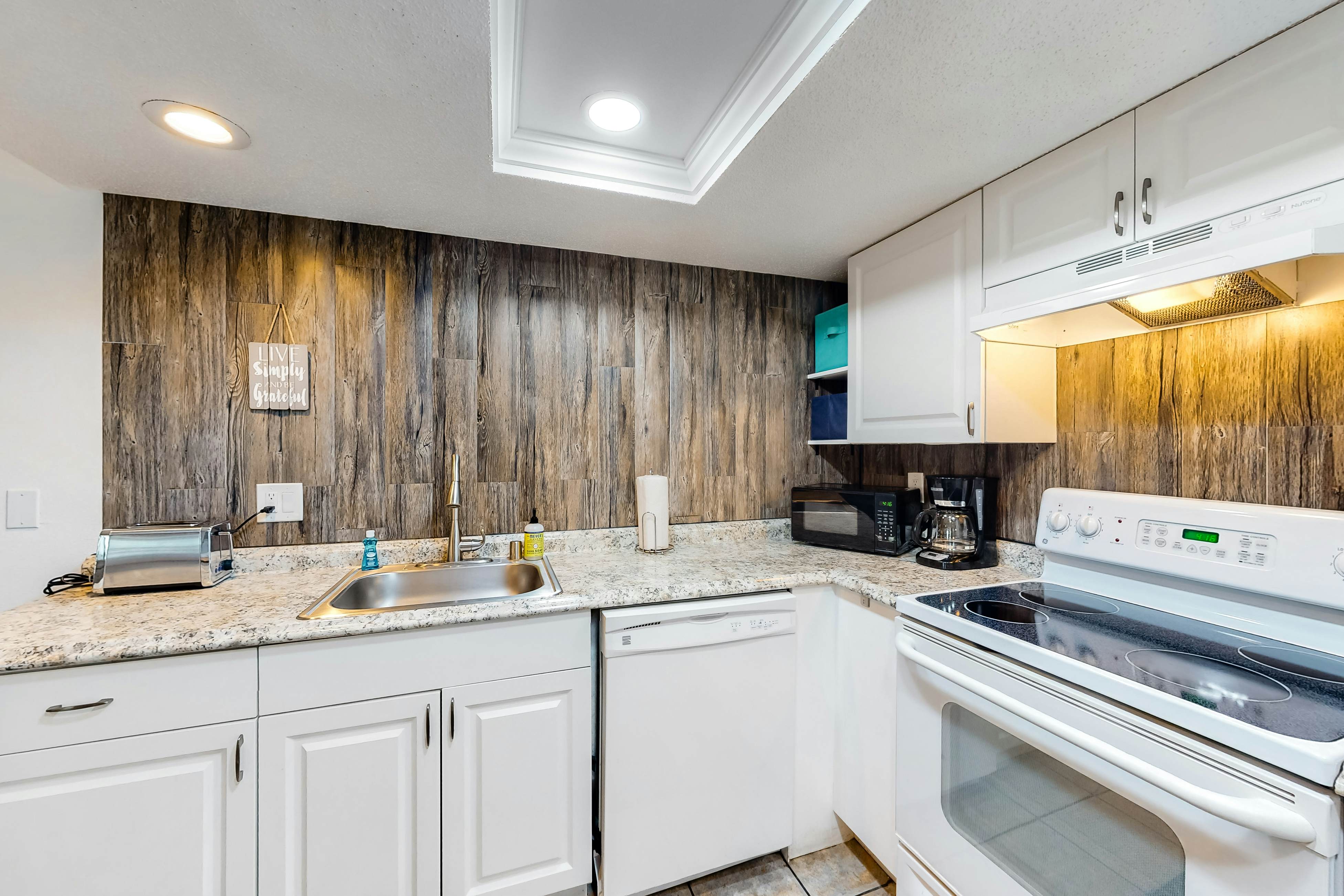 Updated beachside corner condo with pool and private wraparound balcony