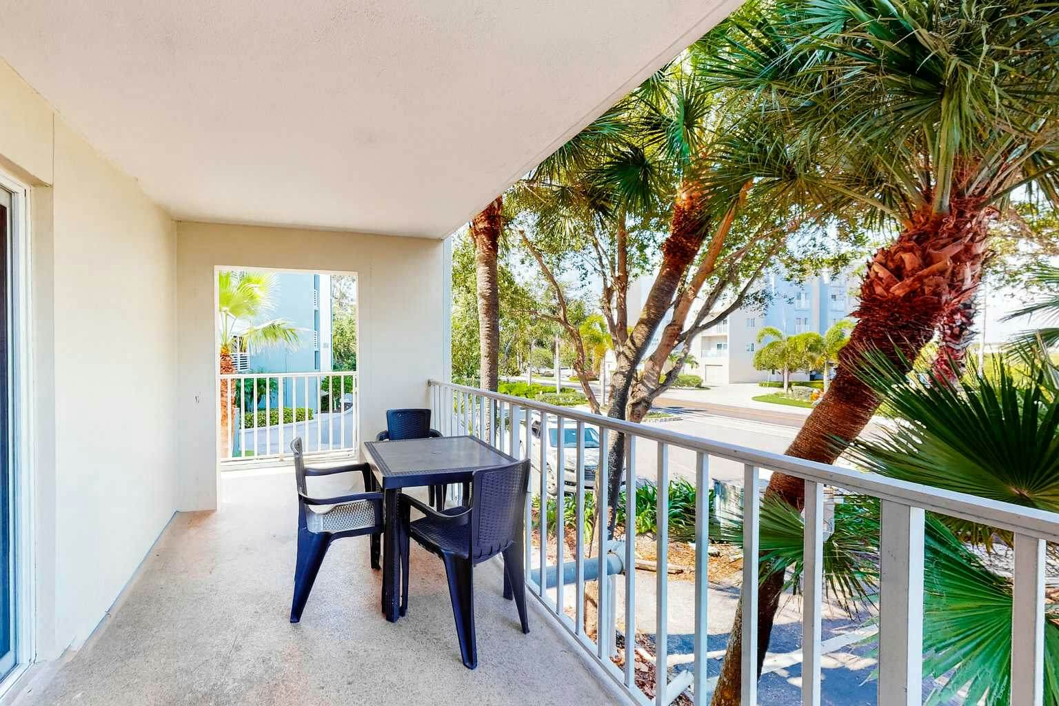 Updated beachside corner condo with pool and private wraparound balcony