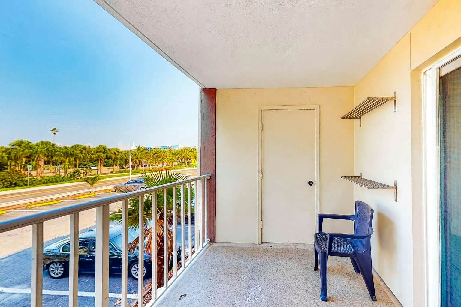 Updated beachside corner condo with pool and private wraparound balcony