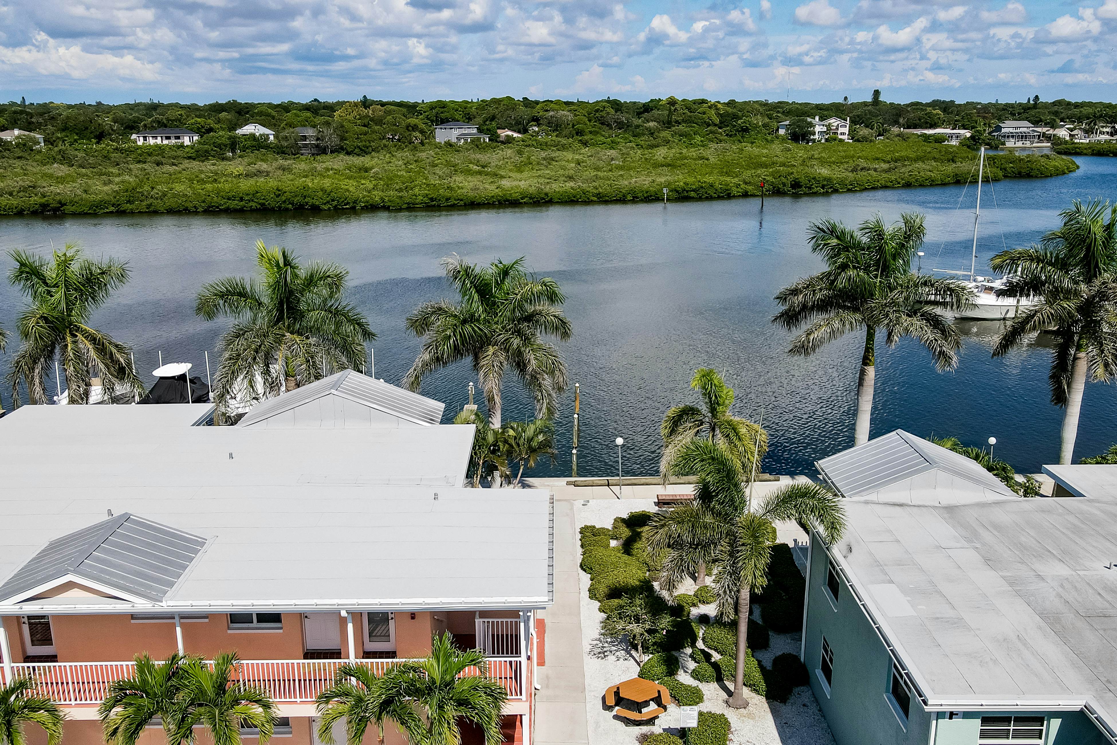 1st-floor condo with private dock, easy beach access, heated pool, & patio