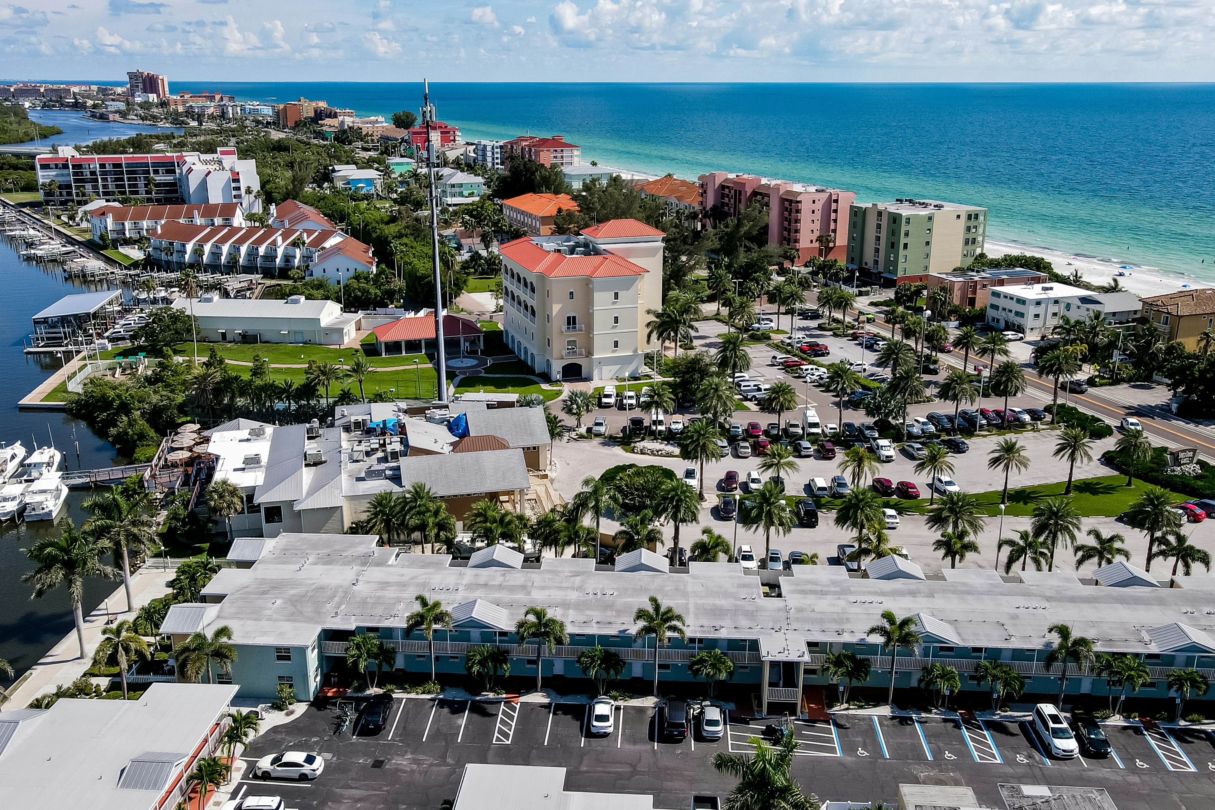 1st-floor condo with private dock, easy beach access, heated pool, & patio