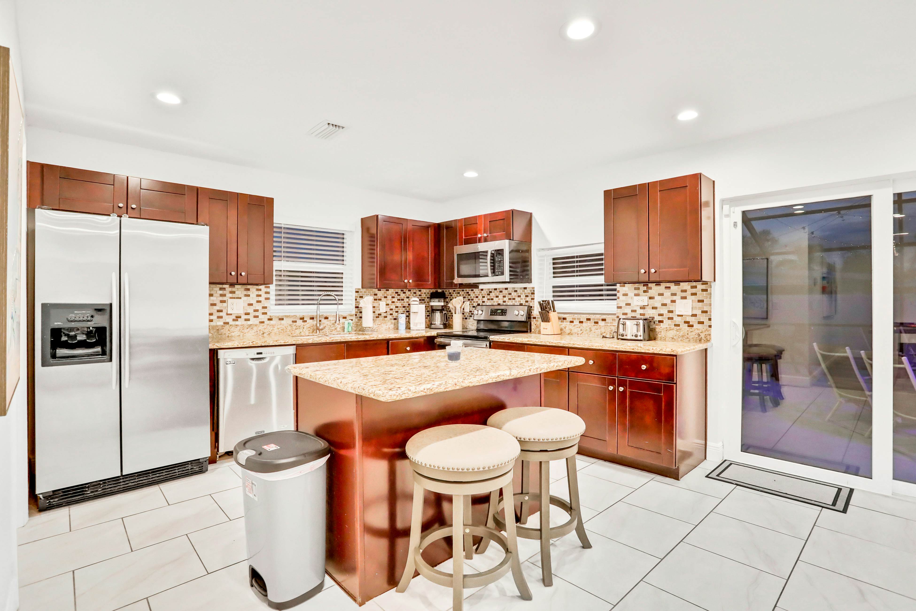 Dog-friendly tropical stay with a private pool, grill, game tables, & central AC