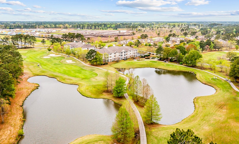 Dreamy lakefront escape on 18th fairway with pools, tennis, & elevator