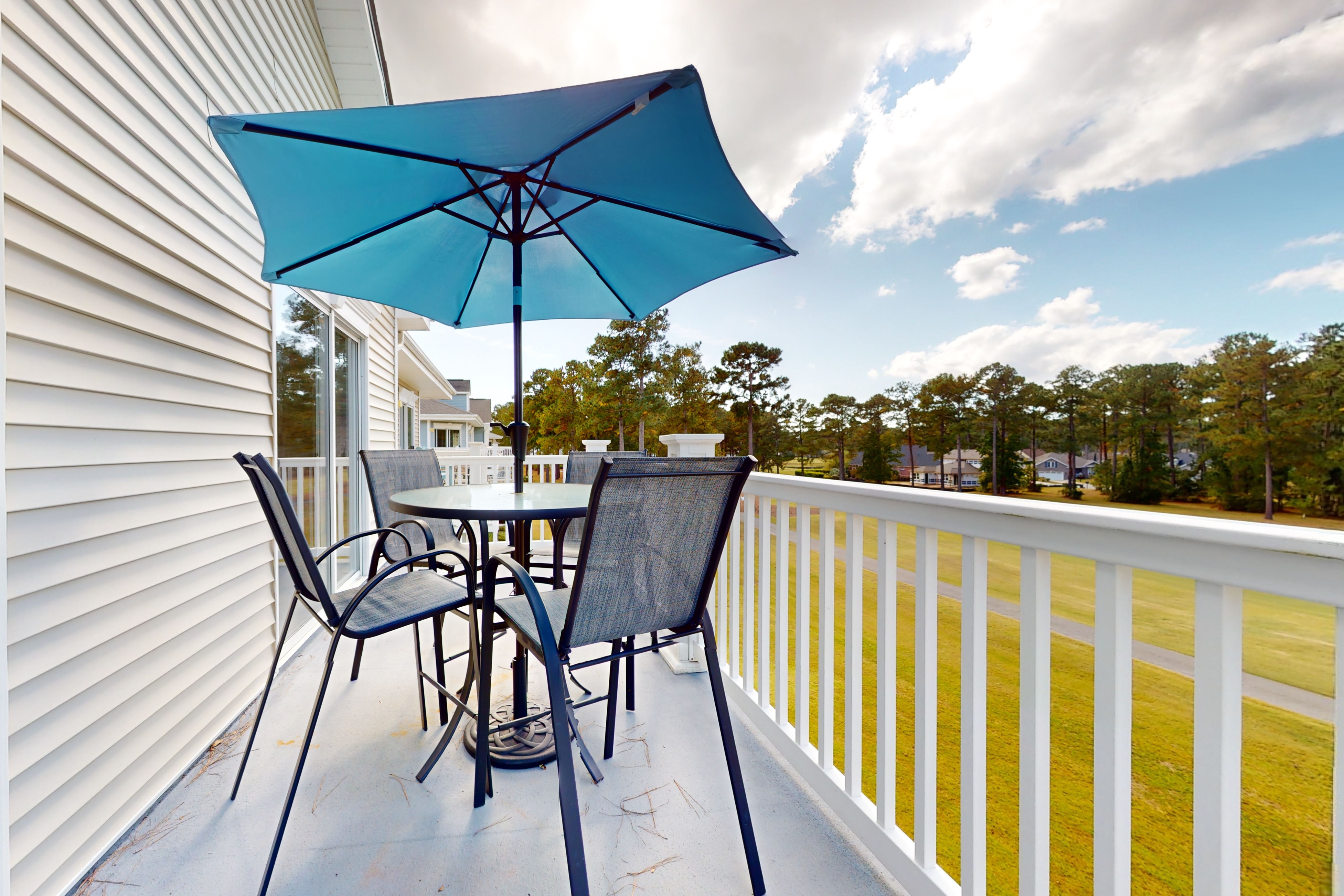 Coastal condo with golf course views, on-site pools, gym, & balcony