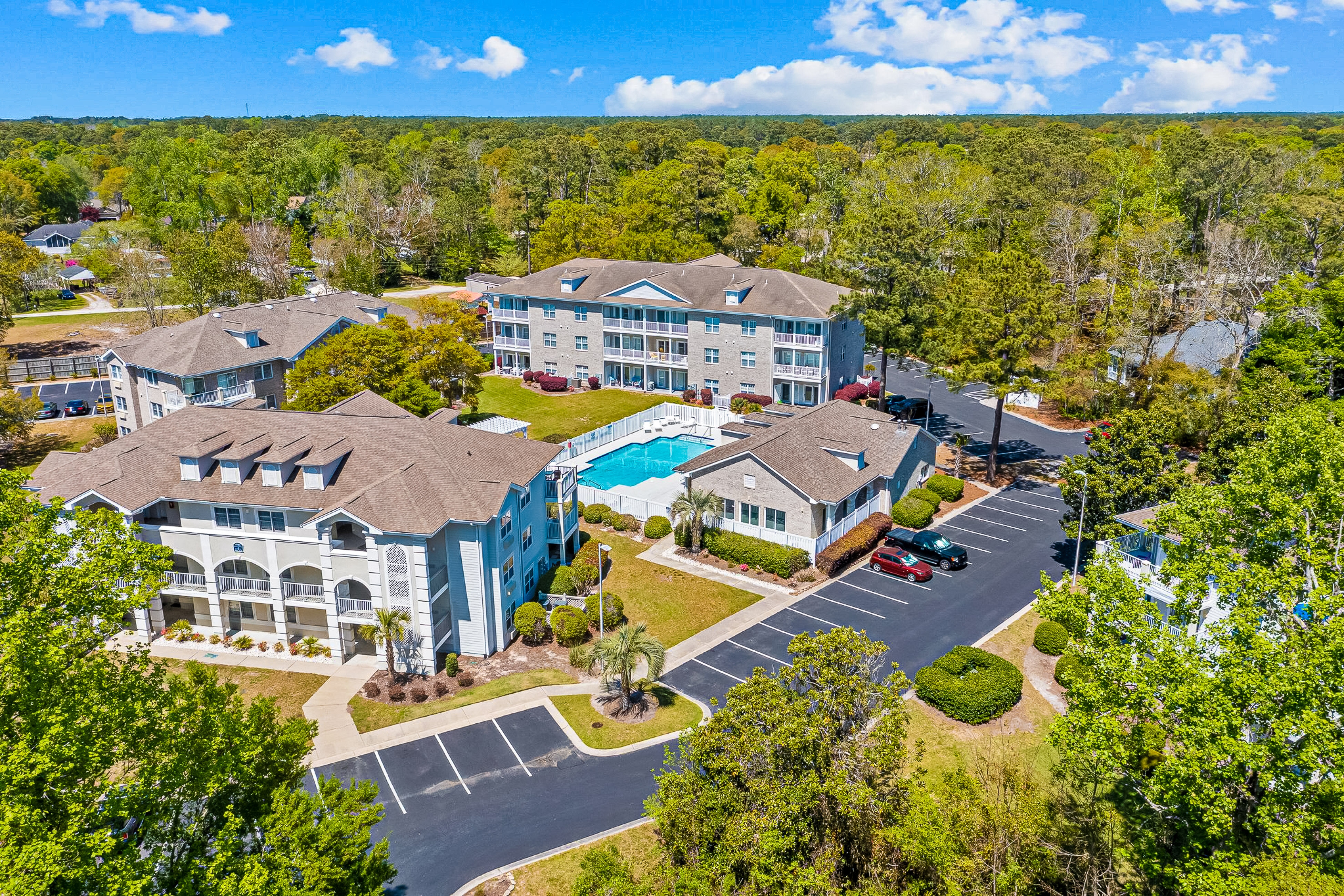 Sunny condo with a pool, balcony, chef's kitchen, beach gear, W/D, & AC