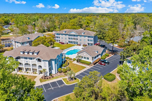 Sunny condo with a pool, balcony, chef's kitchen, beach gear, W/D, & AC