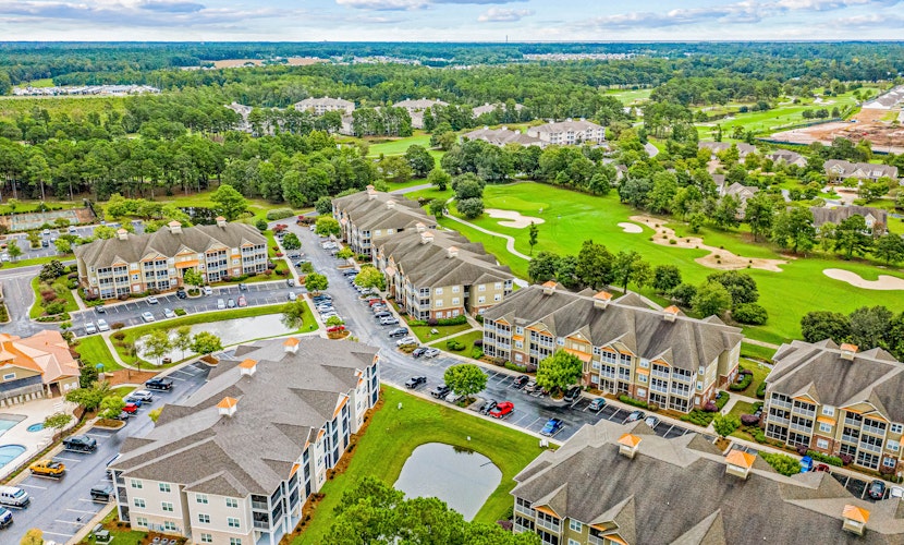 Golf-course-front villa at Crow Creek with screened porch and washer/dryer
