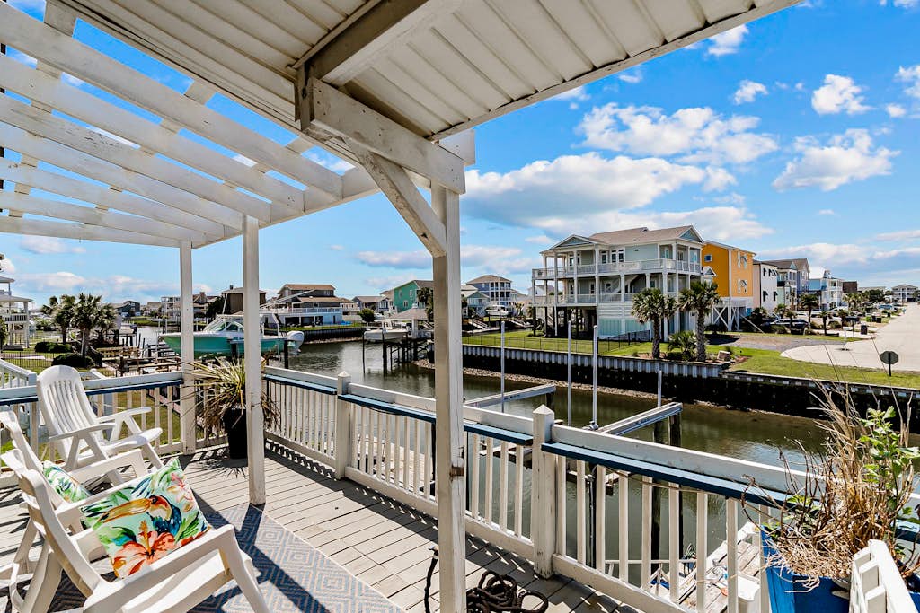 Waterfront home with Intracoastal views, outdoor areas, dock, & golf cart access