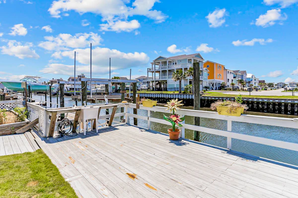 Waterfront home with Intracoastal views, outdoor areas, dock, & golf cart access