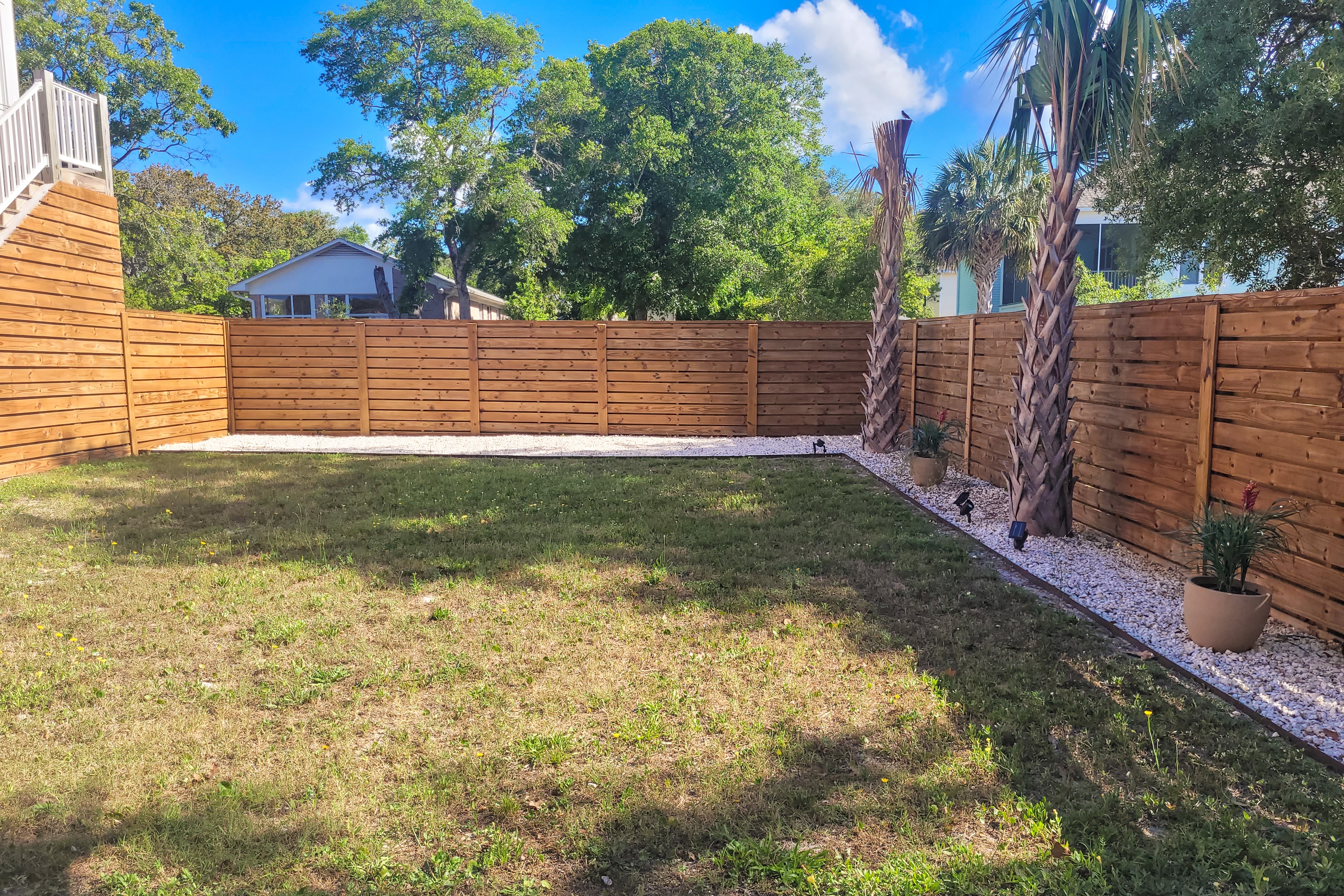 Vibrant beach-themed stay with balconies, enclosed yard, extra kitchenette, & AC