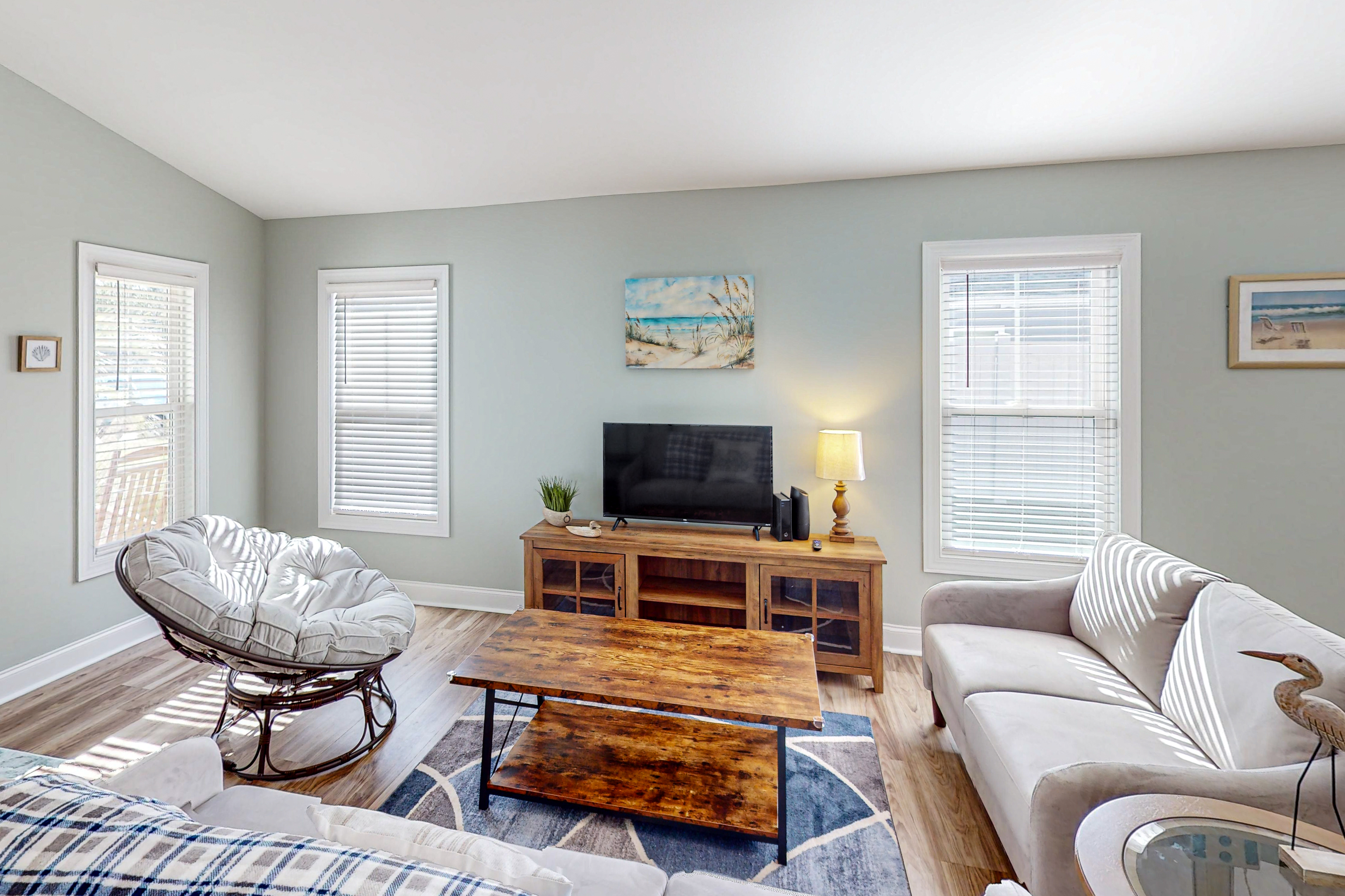 Updated home near the beach with fenced yard, grill, central AC, & washer/dryer