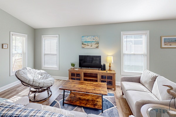 Updated home near the beach with fenced yard, grill, central AC, & washer/dryer