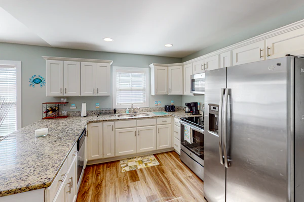 Updated home near the beach with fenced yard, grill, central AC, & washer/dryer