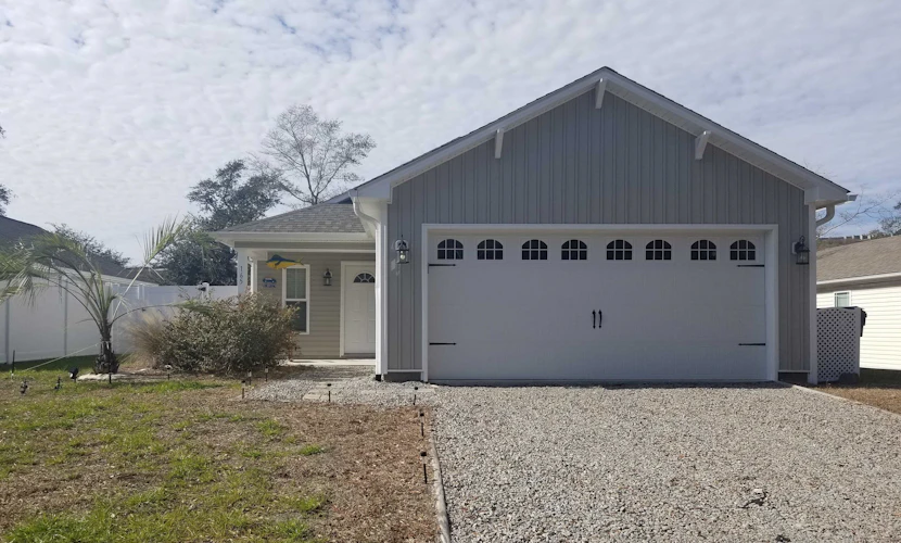 Updated home near the beach with fenced yard, grill, central AC, & washer/dryer