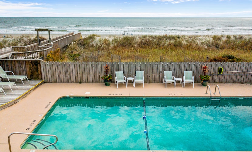 Colorful ocean view condo with pool, central AC, & private washer/dryer