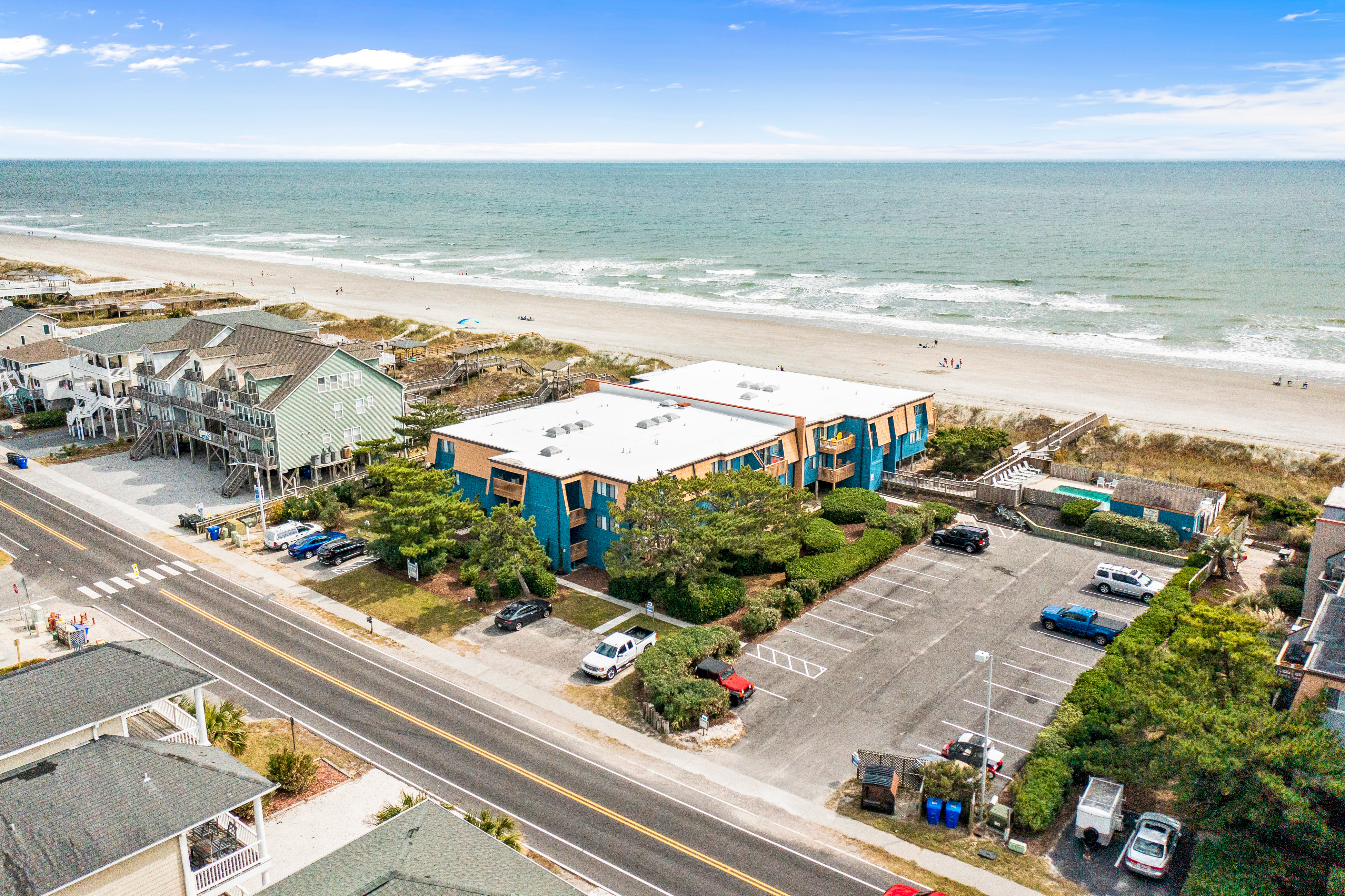 Colorful ocean view condo with pool, central AC, & private washer/dryer