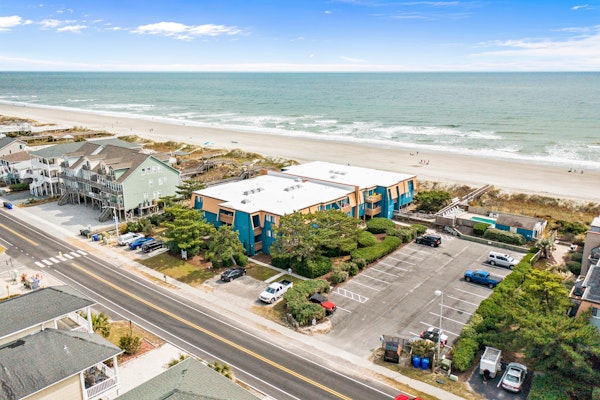 Colorful ocean view condo with pool, central AC, & private washer/dryer