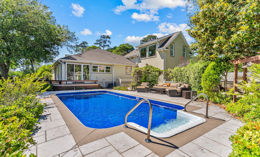 Gorgeous waterfront home with private hot tub, pool, views, deck, & fireplace