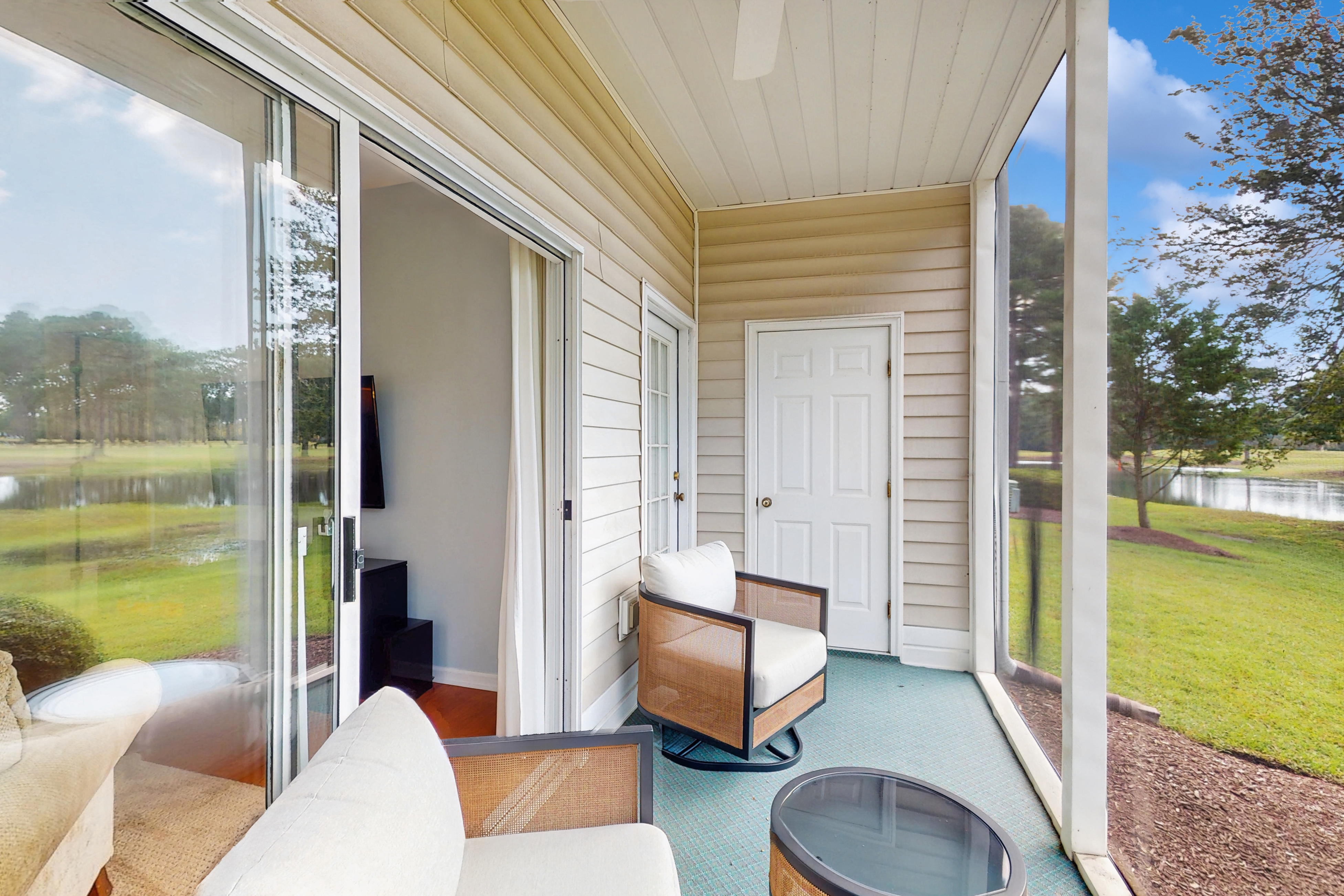 1st-floor corner condo with water view, on-site pool, & screened patio