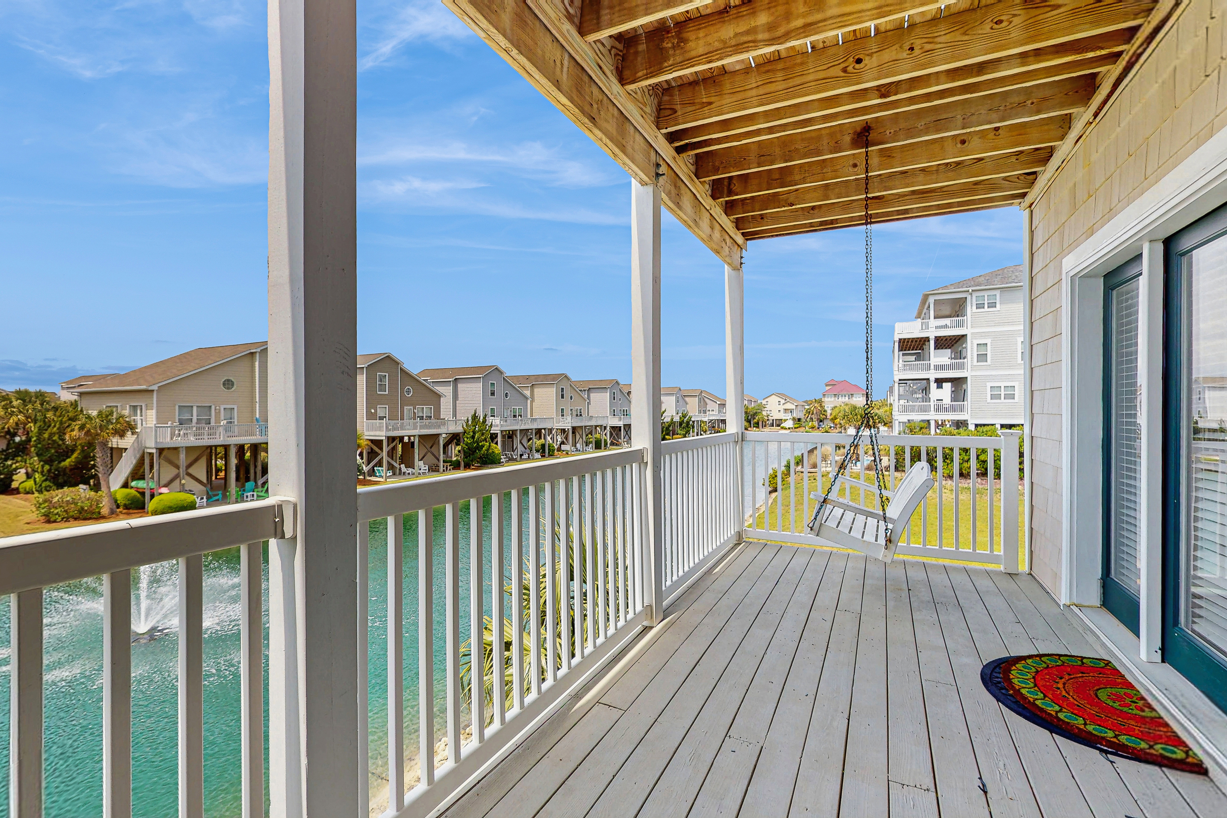 All-suite condo with private balcony &  pond views - walk to beach