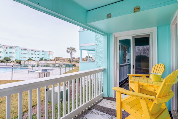 1st-floor pool-view condo with outdoor pool, beach access, balcony, W/D, & AC