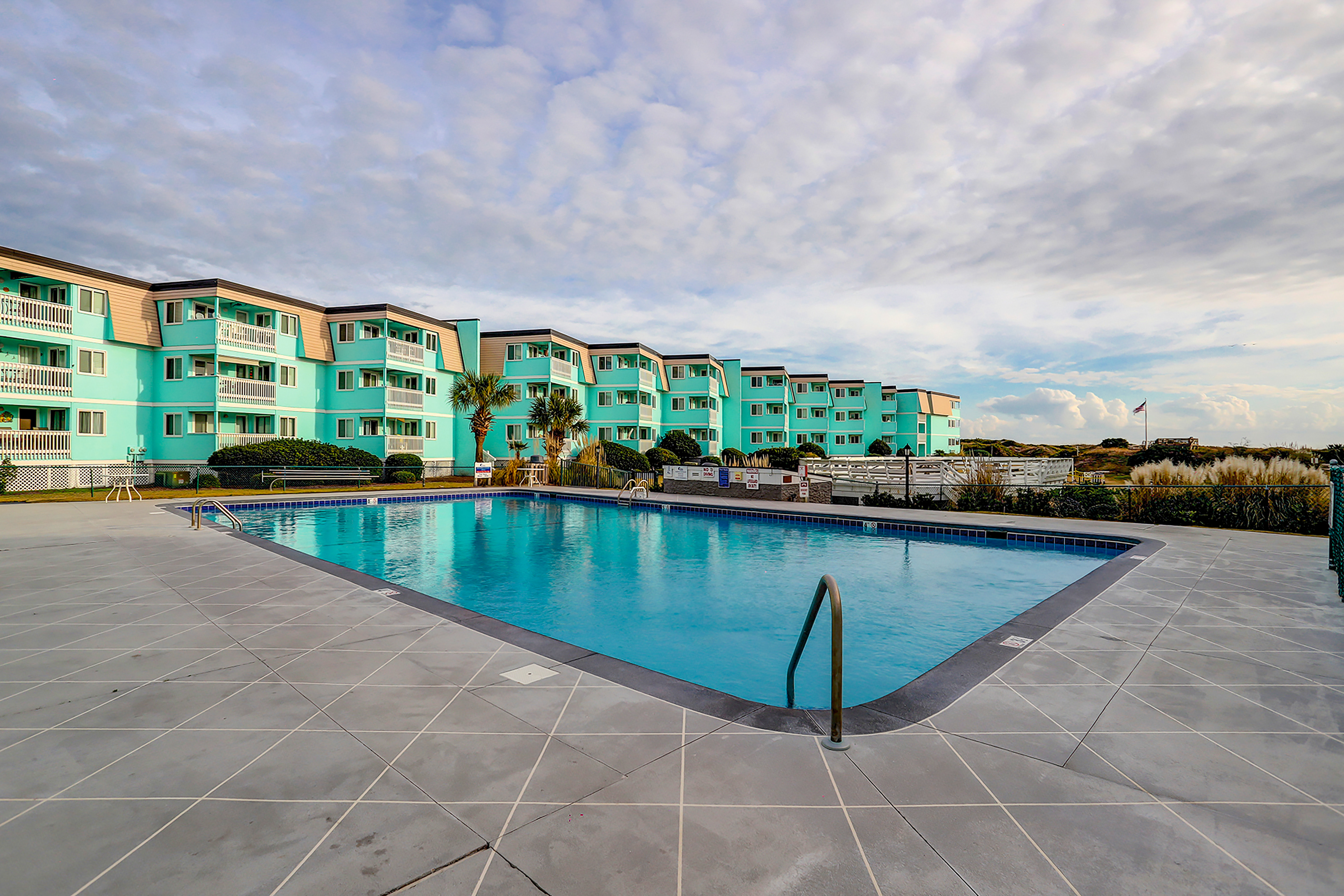 1st-floor pool-view condo with outdoor pool, beach access, balcony, W/D, & AC