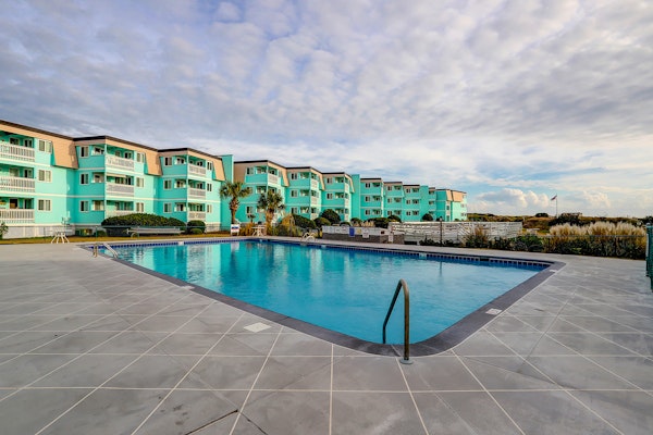 1st-floor pool-view condo with outdoor pool, beach access, balcony, W/D, & AC