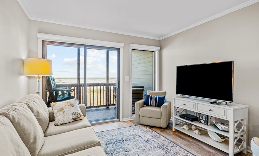 Ocean-view condo with beachfront access, pool, fishing dock, & private balcony