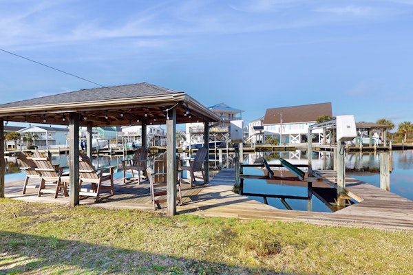 Dog-friendly waterfront home with screened-in patio, hot tub, grill, & W/D