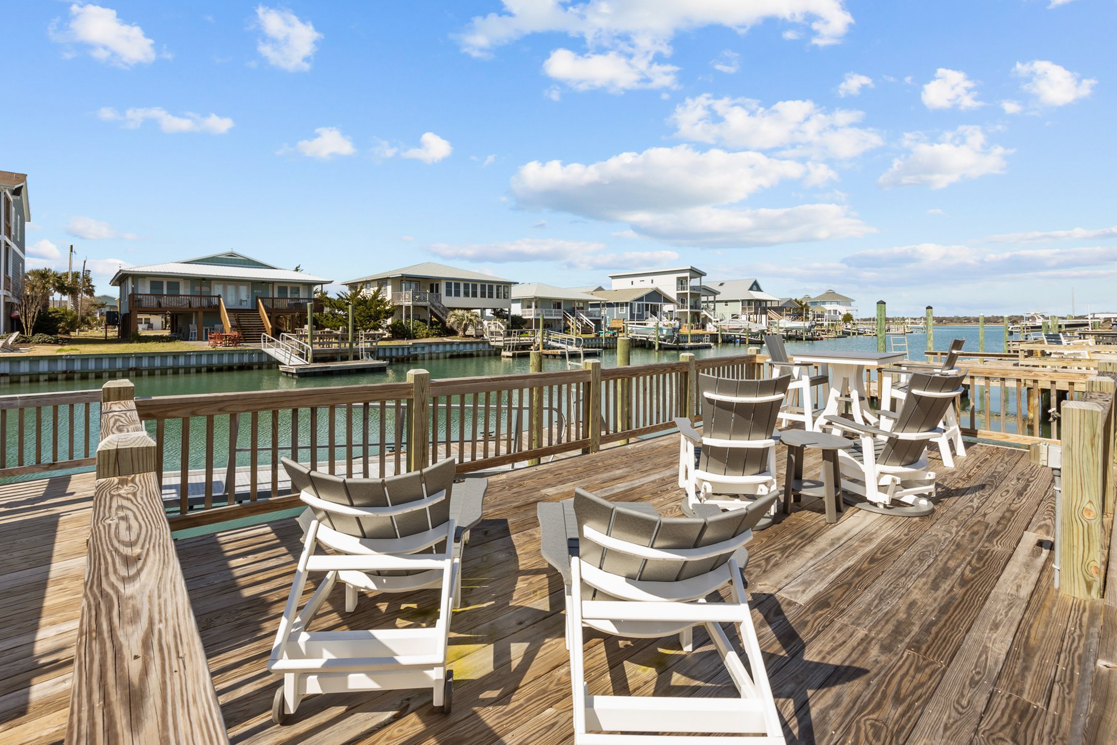 Canal front home with a floating dock and large deck with sound views