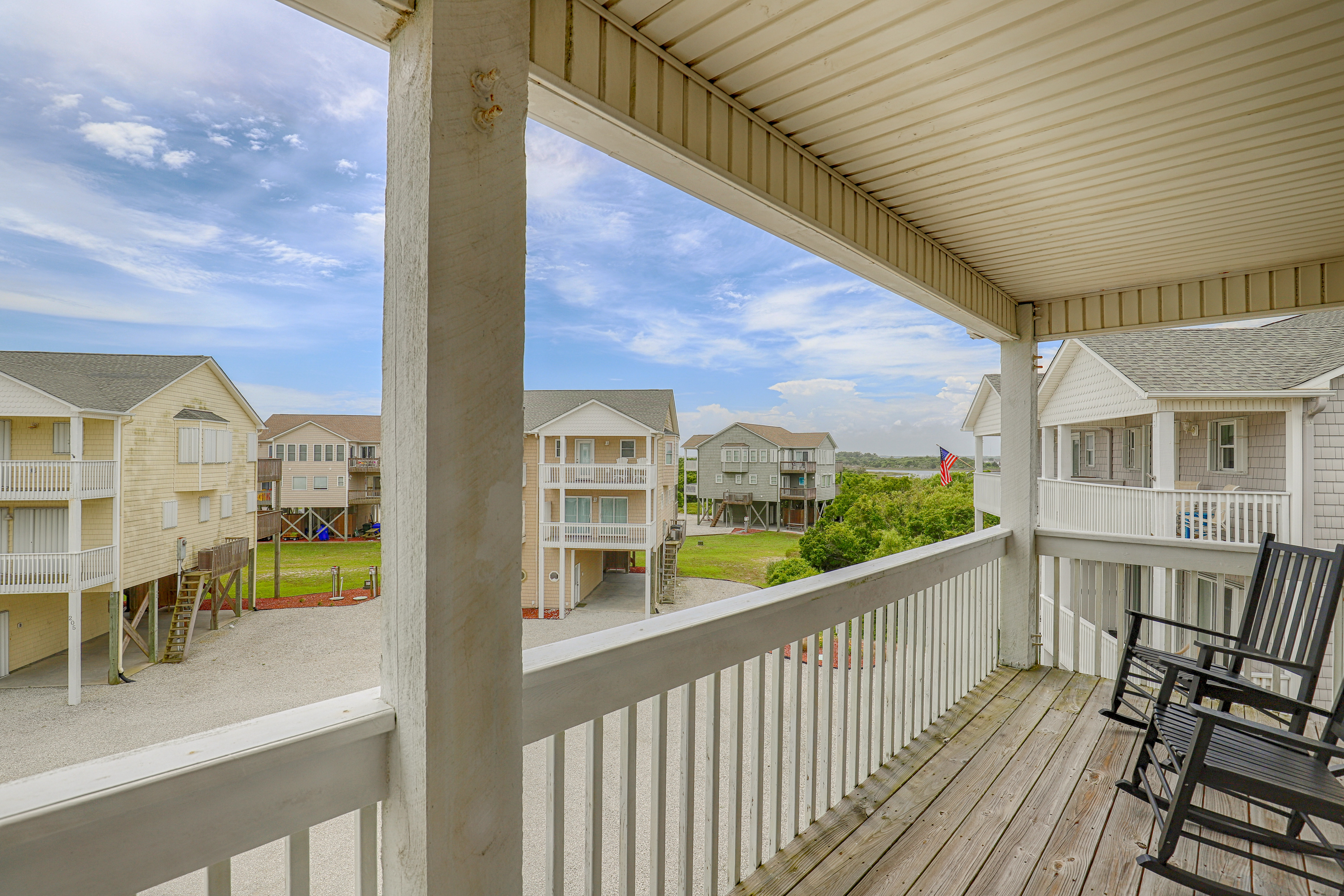Water-view two-story duplex with multiple decks, outdoor shower, washer/dryer