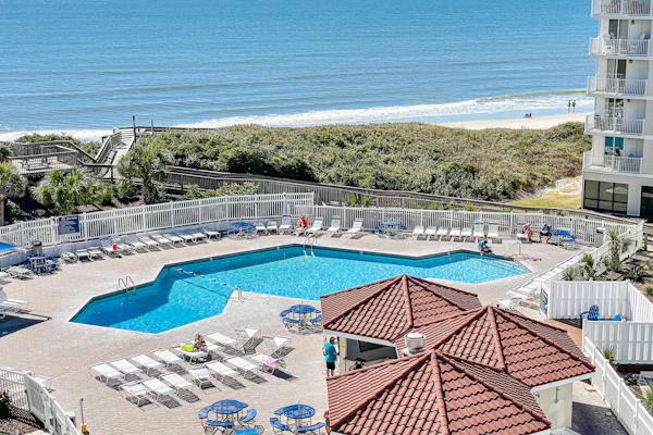 Ocean-view condo with outdoor pool, balcony, W/D, AC, sauna & gym
