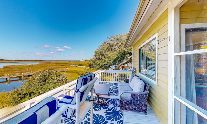 Light-filled coastal stay with open layout, water views, washer/dryer, and AC