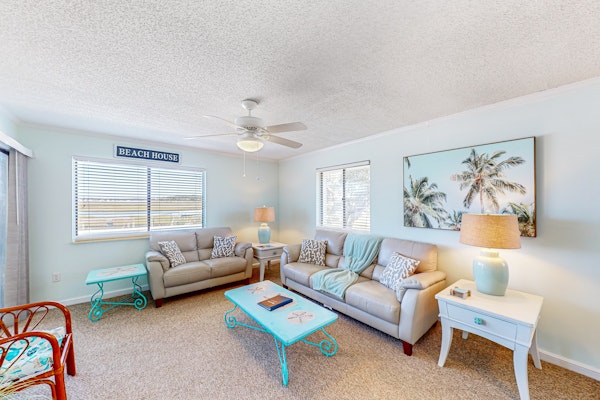 Light-filled coastal stay with open layout, water views, washer/dryer, and AC