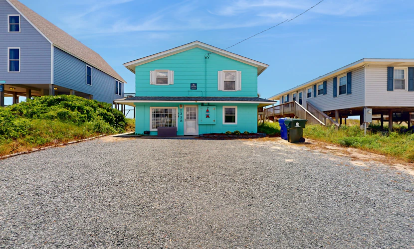 Beachfront dog-friendly home with ocean views, beach access, and outdoor shower
