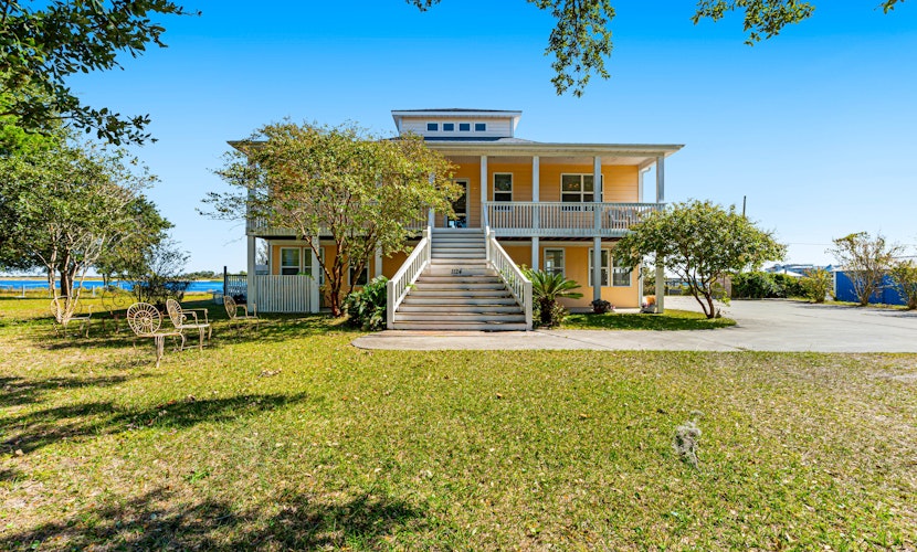 Waterfront charmer with expansive outdoor space, full kitchen, W/D, & central AC