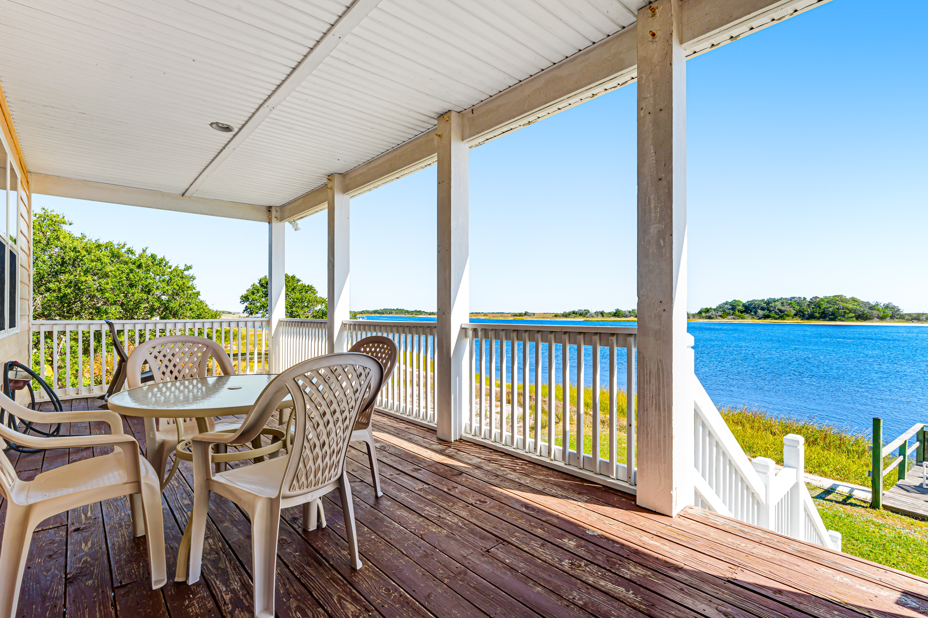 Waterfront charmer with expansive outdoor space, full kitchen, W/D, & central AC