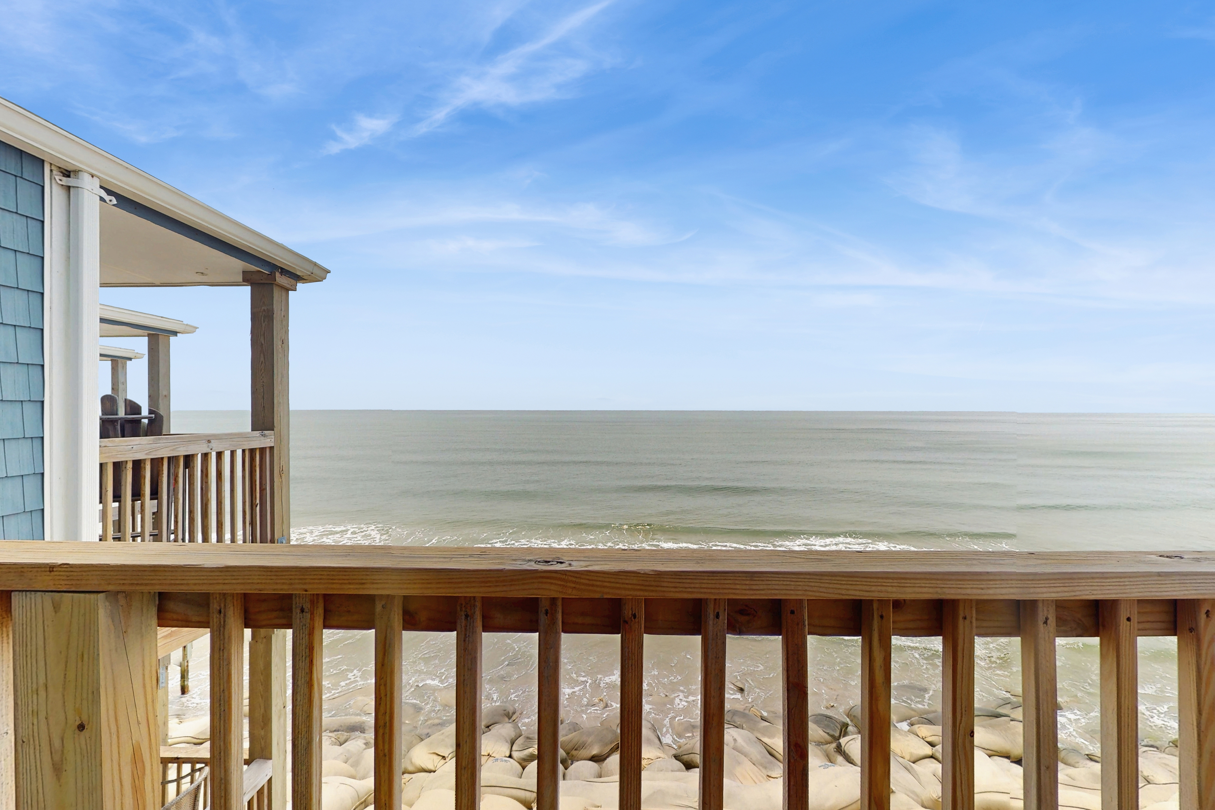 Beachfront condo with ocean views, balcony, WiFi, & shared grills