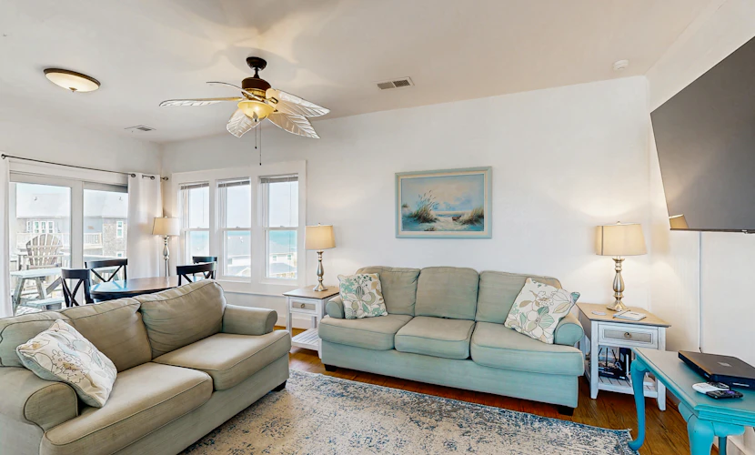 Fun-filled vacation home steps from beach with outdoor pool, AC, W/D, & balcony