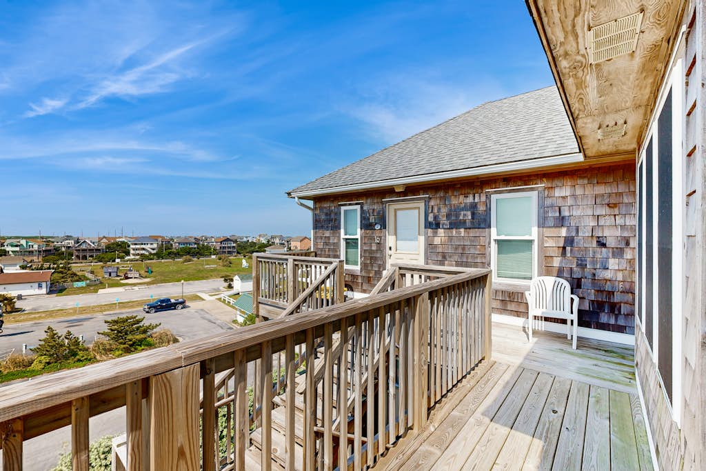 Fun-filled vacation home steps from beach with outdoor pool, AC, W/D, & balcony