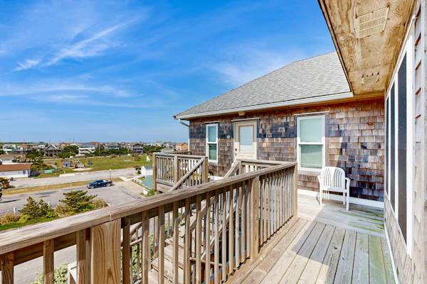 Fun-filled vacation home steps from beach with outdoor pool, AC, W/D, & balcony