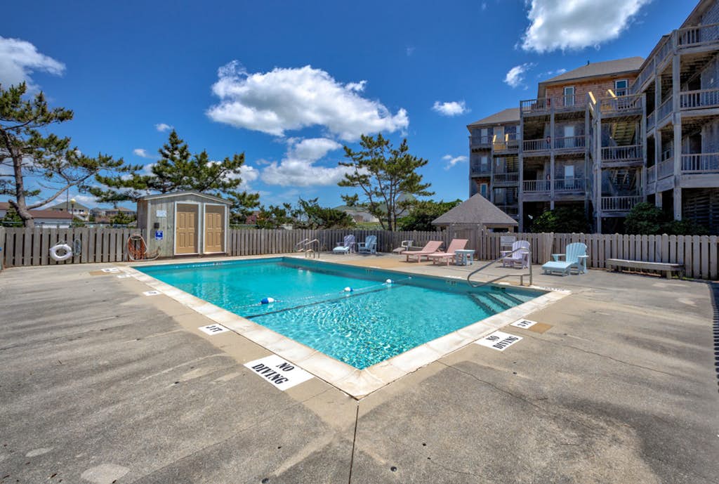 Fun-filled vacation home steps from beach with outdoor pool, AC, W/D, & balcony