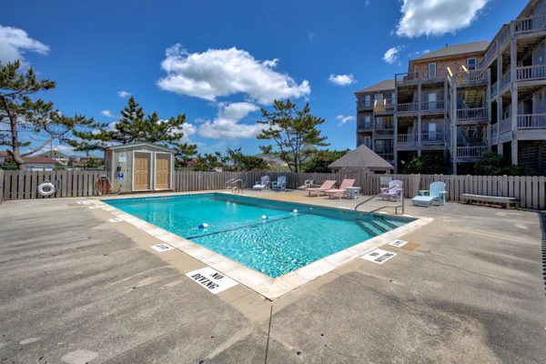 Fun-filled vacation home steps from beach with outdoor pool, AC, W/D, & balcony