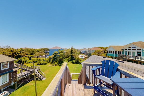 Dog-friendly home steps from beach with yard, multiple decks, and arcade game