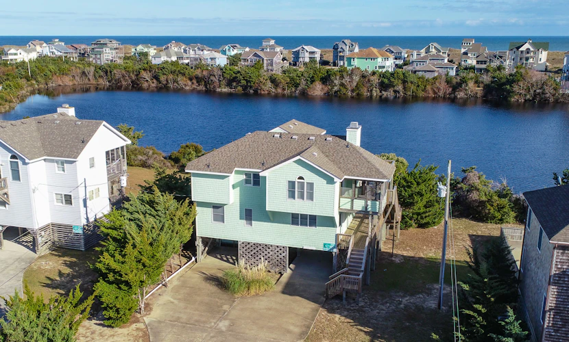 Home on private lake between beach & sound with WiFi, pool & hot tub