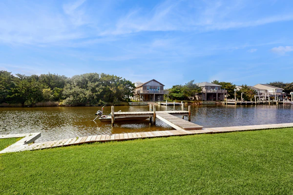 Dog-friendly, canal-front house with dock, balcony, deck, & central AC
