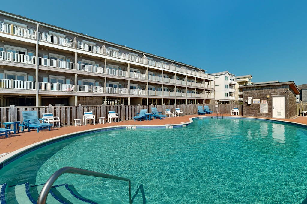 Inviting beachfront condo featuring hot tub & pool, central AC, elevator, & deck
